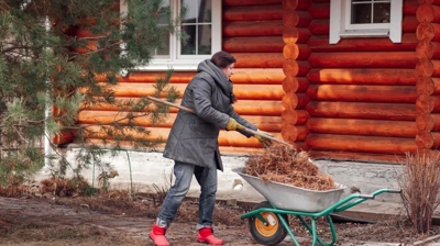 woman taking care of the lawn on a winter day