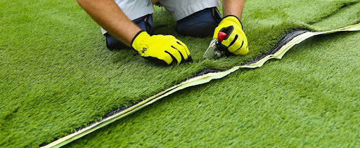 man installing artificial turf