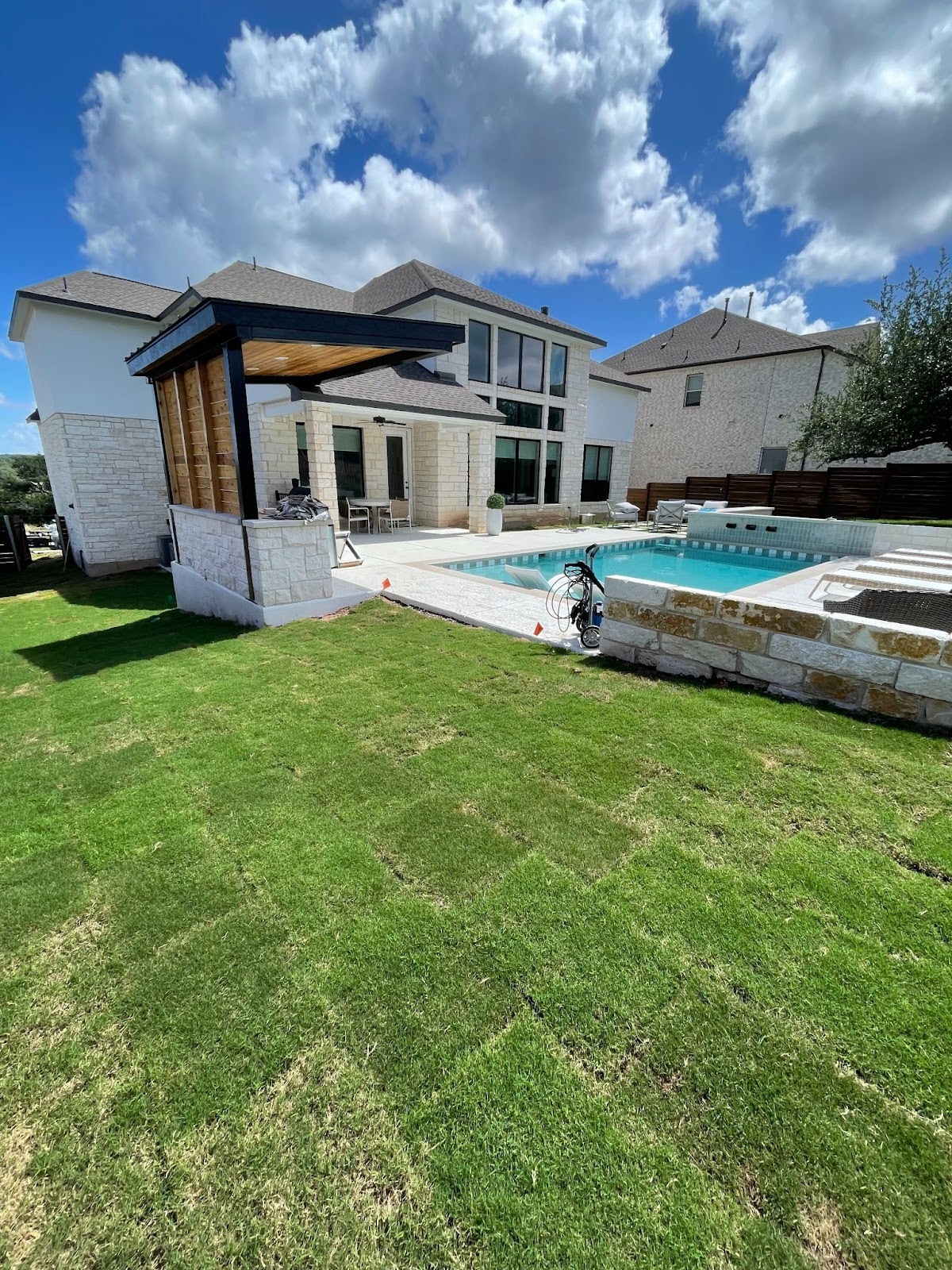 sod installation in a backyard with a pool